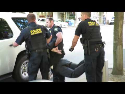 homeland security pulls guns and arrest protester and pain compliance