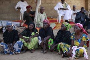 File - In this photo taken Sunday, May 18, 2014, some of the mothers of the kidnapped school girls sit in Chibok, Nigeria. More than 200 schoolgirls were kidnapped from a school in Chibok by Boko Haram on April 14, 2014.