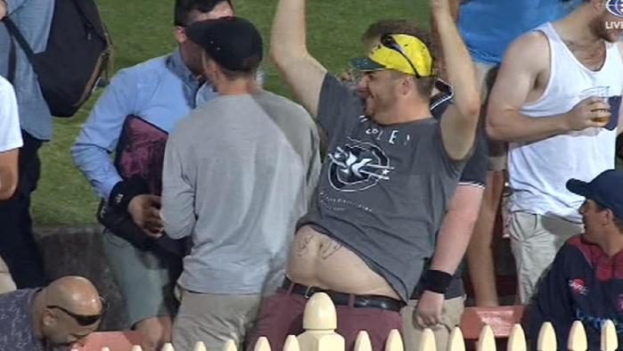 A spectator at North Sydney Oval celebrates after having his stomach signed by Peter Handscomb.