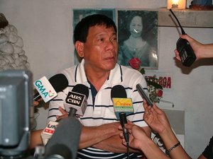 Davao City Mayor Rodrigo Duterte answers questions from reporters during a press conference at the Roman Catholic Cemetery in Davao City, Philippines.