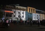 People gather outside the private Sum Hospital after a fire broke out in its intensive care unit, in Bhubaneswar, in the eastern Indian state of Orissa, India