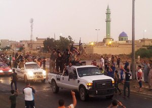 In this file photo taken Wednesday, June 25, 2014, fighters of the al-Qaida-inspired Islamic State of Iraq and the Levant (ISIL) parade in the northern city of Mosul, Iraq.