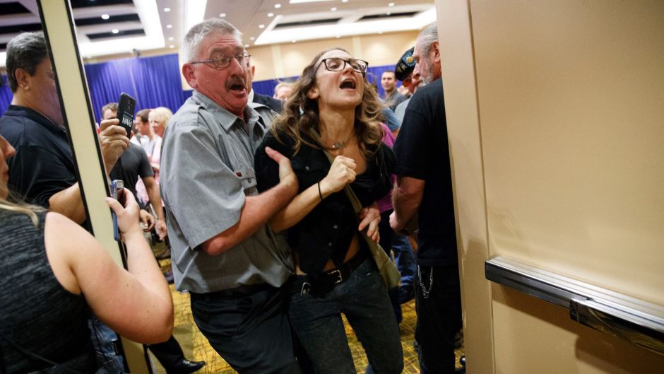 A demonstrator is removed during a campaign rally for Republican presidential candidate Donald Trump, Monday, Oct. 17, ...