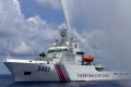 A Chinese Coast Guard boat sprays a water cannon at Filipino fishermen near Scarborough Shoal in the South China Sea ...