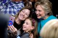 Feeling emboldened: Hillary Clinton gets a selfie with supporters.