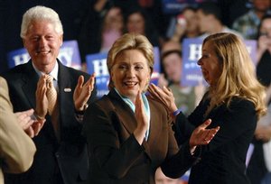 Democratic presidential hopeful Sen. Hillary Rodham Clinton, D-N.Y., center, acknowledges supporters with her husband former president Bill Clinton and daughter Chelsea during her Kentucky primary election night rally Tuesday, May 20, 2008 in Louisville, Ky. Clinton won the Kentucky primary.