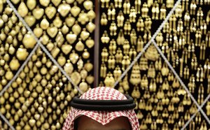 A Saudi vendor waits customers at gold shop in a market near the Grand Mosque in the holy city of Mecca, Saudi Arabia, Tuesday, Oct. 23, 2012. The annual Islamic pilgrimage draws three million visitors each year, making it the largest yearly gathering of people in the world