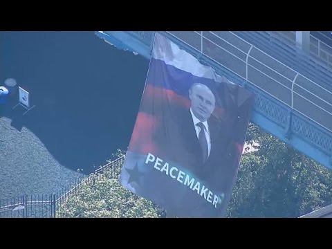 Banner calling Vladimir Putin a peacemaker hangs from Manhattan bridge