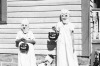 A trio of kids dressed up as ghosts are ready for trick or treating.