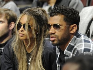 Singer and actress Ciara, left, and Seattle Seahawks quarterback Russell Wilson look on during the McDonald's All-American Girls basketball game, Wednesday, March 30, 2016, in Chicago.