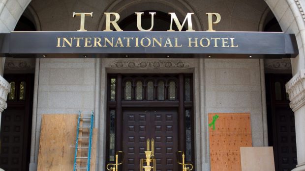 Plywood covers up graffiti at the entrance to the Trump Hotel in Washington.