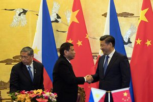 Philippine President Rodrigo Duterte, left and Chinese President Xi Jinping shakes hands after a signing ceremony held in Beijing, China, Thursday, Oct. 20, 2016.