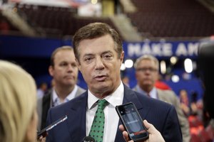 Trump Campaign Chairman Paul Manafort talks to reporters on the floor of the Republican National Convention at Quicken Loans Arena, Sunday, July 17, 2016, in Cleveland.