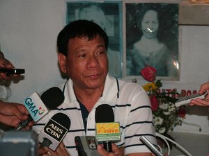 Davao City Mayor Rodrigo Duterte answers questions from reporters during a press conference at the Roman Catholic Cemetery in Davao City, Philippines.