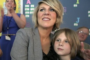 Kirsten Langhammer sits with her son, Jacob, 8, during a poetry reading at his school.