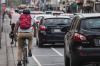 Cyclists navigate busy traffic.