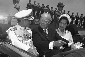 FILE - In this June 28, 1960, file photo, U.S. President Dwight Eisenhower, center, is seated between Thailand's King Bhumibol Adulyadej, left, and Queen Sirikit for a motorcade drive from National Airport to the White House in Washington.