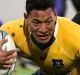 Israel Folau is tackled by Ardie Savea in Wellington. 