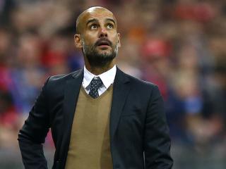 Bayern's head coach Pep Guardiola watches the stadium score board during the German Bundesliga soccer match between FC Bayern Munich and Borussia Dortmund at the Allianz Arena stadium in Munich, Germany, Sunday, Oct. 4, 2015. (AP Photo/Matthias Schrader)