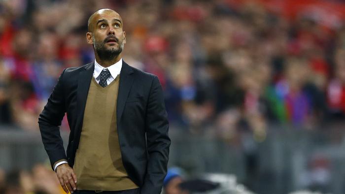 Bayern's head coach Pep Guardiola watches the stadium score board during the German Bundesliga soccer match between FC Bayern Munich and Borussia Dortmund at the Allianz Arena stadium in Munich, Germany, Sunday, Oct. 4, 2015. (AP Photo/Matthias Schrader)