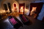 Two coffins are lit before a photo shoot in Bran Castle, in Bran, Romania. Airbnb has launched a contest to find two ...