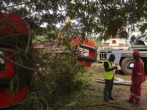 Rescue workers, right, near the debris of a derailed train in Eseka, Cameroon, Saturday, Oct. 22, 2016. Rescue workers dug through the rubble Saturday in search of more injured and dead after a train traveling between two major cities in Cameroon derailed Friday in Eseka