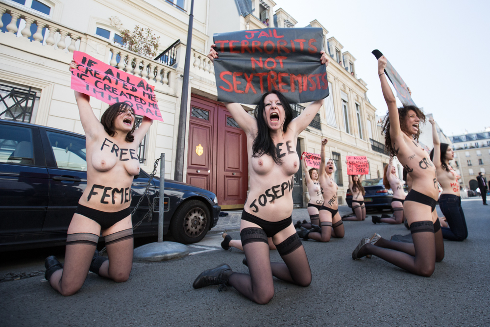 In front of Tunisian embassy, 10 Femen activists praying for their activists in Jail in Tunsia.