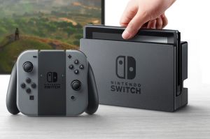 The Switch console is pictured here in its TV dock. The two controller modules, pictured here attached to the grip, can ...