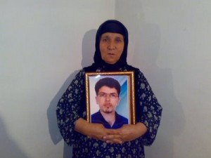 Farzad's mother holds up his picture