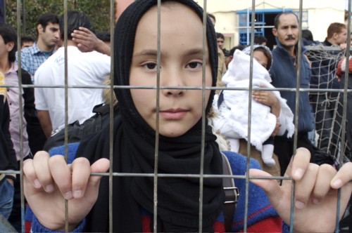 young girl behind bars