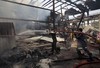 Firefighters work to extinguish fire at a food factory hit by Saudi-led airstrikes in Sanaa, Yemen, Tuesday, Aug. 9, 2016.