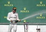 Mercedes driver Lewis Hamilton, of Britain, celebrates his win in the Formula One U.S. Grand Prix auto race at the Circuit of the Americas