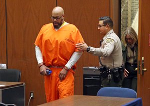 In this Oct. 27, 2015 file photo, former rap mogul Marion "Suge" Knight is led into court for his arraignment on robbery charges, in Los Angeles.