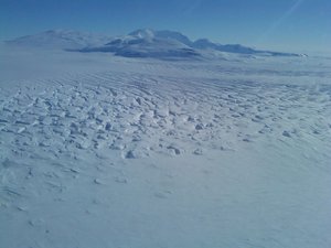 File - Mt. Murphy broke the monotony of the mostly flat and barren icy white landscape of West Antarctica. Fractures in the glacial ice of the Pine Island Glacier were evident in this photo taken during the last flight in the Fall 2010 Operation IceBridge environmental science mission as the glacier moved slowly into Pine Island Bay.