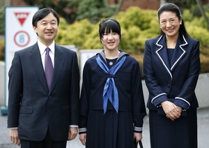 Japan's Princess Aiko, center, accompanied by her parents Crown Prince Naruhito, left, and Crown Princess Masako, answers a reporter's question as they attend her entrance ceremony at the Gakushuin Girls' Junior High School in Tokyo