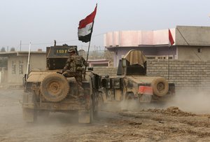 Iraq's elite counterterrorism forces advance toward Islamic State positions in the village of Tob Zawa, about 9 kilometers (5½ miles) from Mosul, Iraq, Tuesday, Oct. 25, 2016.