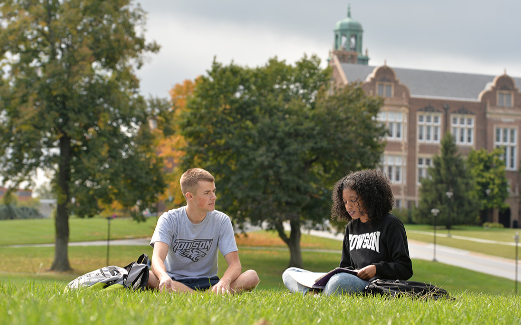 Two TU students sitting in field