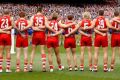 MELBOURNE, AUSTRALIA - OCTOBER 01: Swans players line up for the national anthem during the 2016 Toyota AFL Grand Final ...