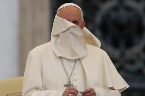 A gust of wind blows the mantle of Pope Francis as he leads a Marian vigil prayer in St. Peter's square at the Vatican.