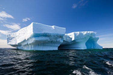 Stunning tabular iceberg drifting off the coast of Antarctica Peninsula around Astrolabe Island. Shot from a zodiac ...