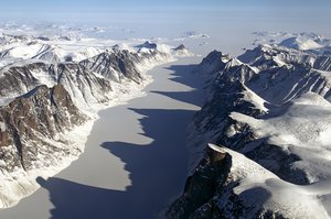 File - The image captures ice covered fjord on Baffin Island with Davis Strait in the background.