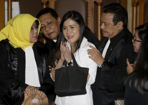 Murder suspect Jessica Kumala Wongso, center, is surrounded by her lawyers after her sentencing at Central Jakarta District Court in Jakarta, Indonesia, Thursday, Oct. 27, 2016.