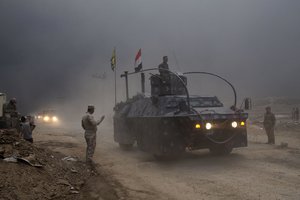 An Iraqi Federal Police vehicle passes through a checkpoint in Qayara, some 50 kilometers south of Mosul, Iraq, Wednesday, Oct. 26, 2016.