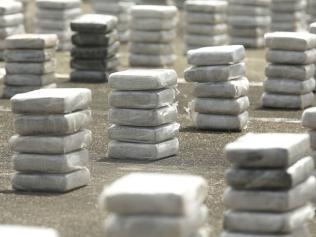 In this Oct. 17, 2016 photo, packages containing cocaine are displayed on the ground before a press conference at a naval base in Panama City. According to authorities police seized more than 2400 packages of cocaine during the weekend hidden in Panama's Caribbean coast. (AP Photo/Arnulfo Franco)