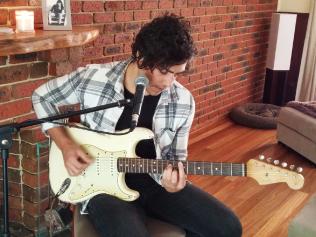 Matt Darvidis and his Stratocaster guitar.