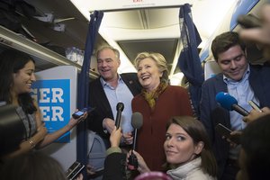 Democratic presidential candidate Hillary Clinton and Democratic vice presidential candidate Sen. Tim Kaine, D-Va., speak to reporters on board the campaign airplane, Saturday, Oct. 22, 2016, in Pittsburgh, Pa.