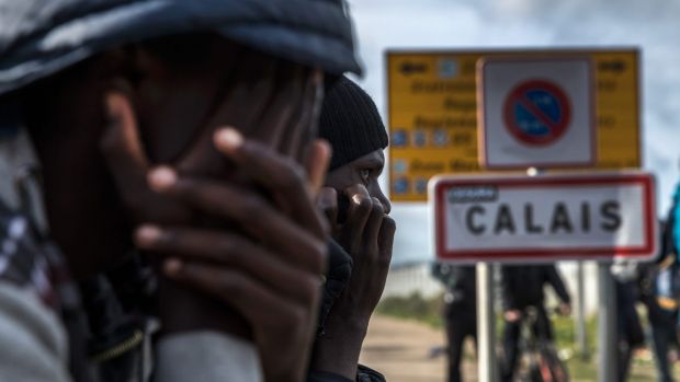 Some of the last remaining migrants in the Calais Jungle on Thursday.