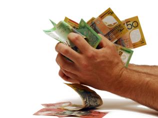 Australian cash money notes scrunched in hands.