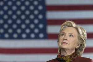 Democratic presidential candidate Hillary Clinton listens as Democratic vice presidential candidate Sen. Tim Kaine, D-Va., speaks during a campaign event at the Taylor Allderdice High School, Saturday, Oct. 22, 2016, in Pittsburgh, Pa.