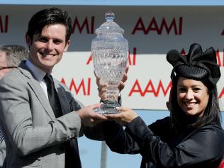 Trainer James Cummings celebrates with his wife Monica and the trophy after winning the Victoria Derby on Derby Day at Flemington Racecourse in Melbourne, Saturday. Oct. 29, 2016. (AAP Image/Mal Fairclough) NO ARCHIVING, EDITORIAL USE ONLY